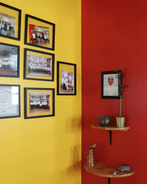 cornor of school with photos and certificates hanging in left wall, and alter and photo on right wall